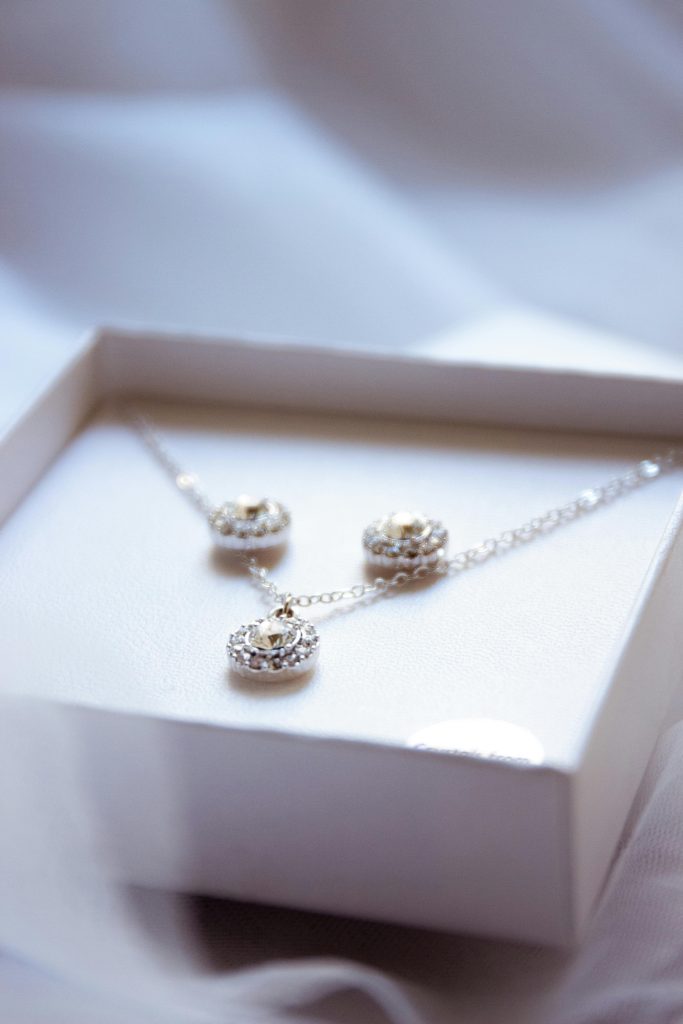 Luxurious diamond necklace and earrings set in an elegant box, perfect for gifting.